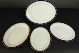 Four Royal Worcester vitreous gilt and royal blue design oval ceramic serving platters. Maker's