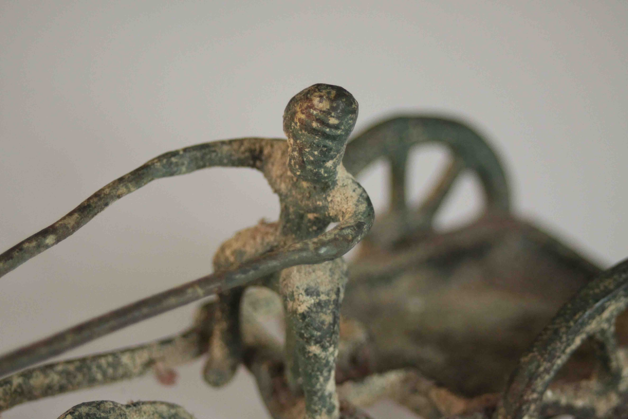 An ancient Greek style bronze of a man riding a horse drawn cart. H.8 W.14 D.6cm. - Image 6 of 8