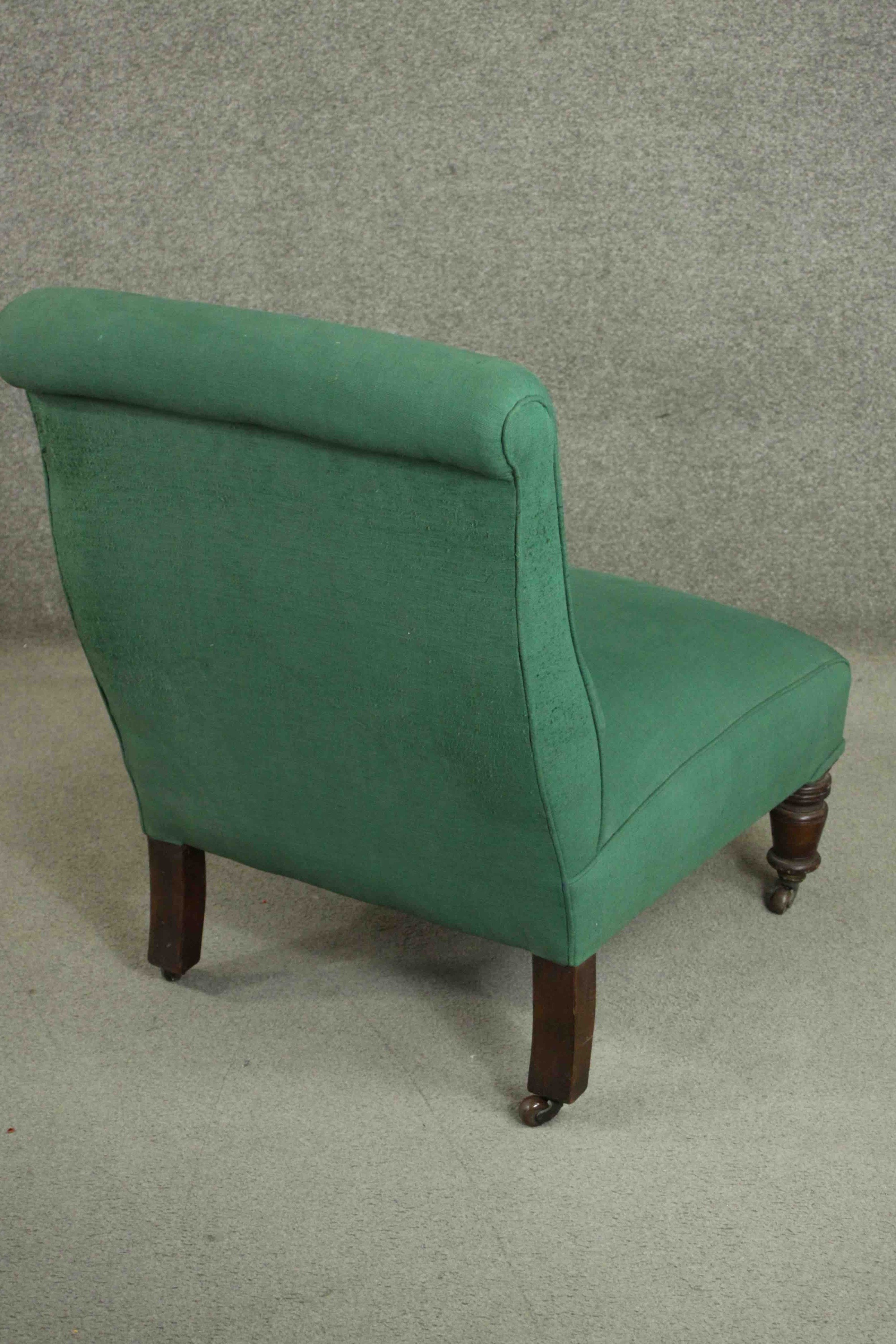 A Victorian mahogany nursing chair, upholstered in green fabric, on ring turned legs. H.85 W.61 D. - Image 4 of 5