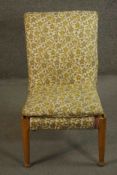 A mid 20th century teak Parker Knoll bedroom chair, upholstered in pink fabric, with a patterned