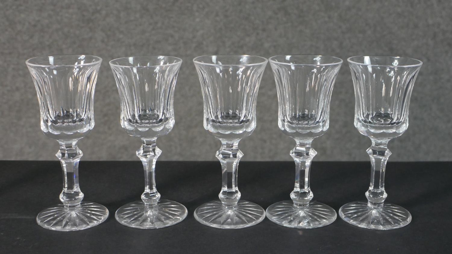 A collection of seven hand cut Waterford crystal wine and sherry glasses with star cut bases. - Image 2 of 6