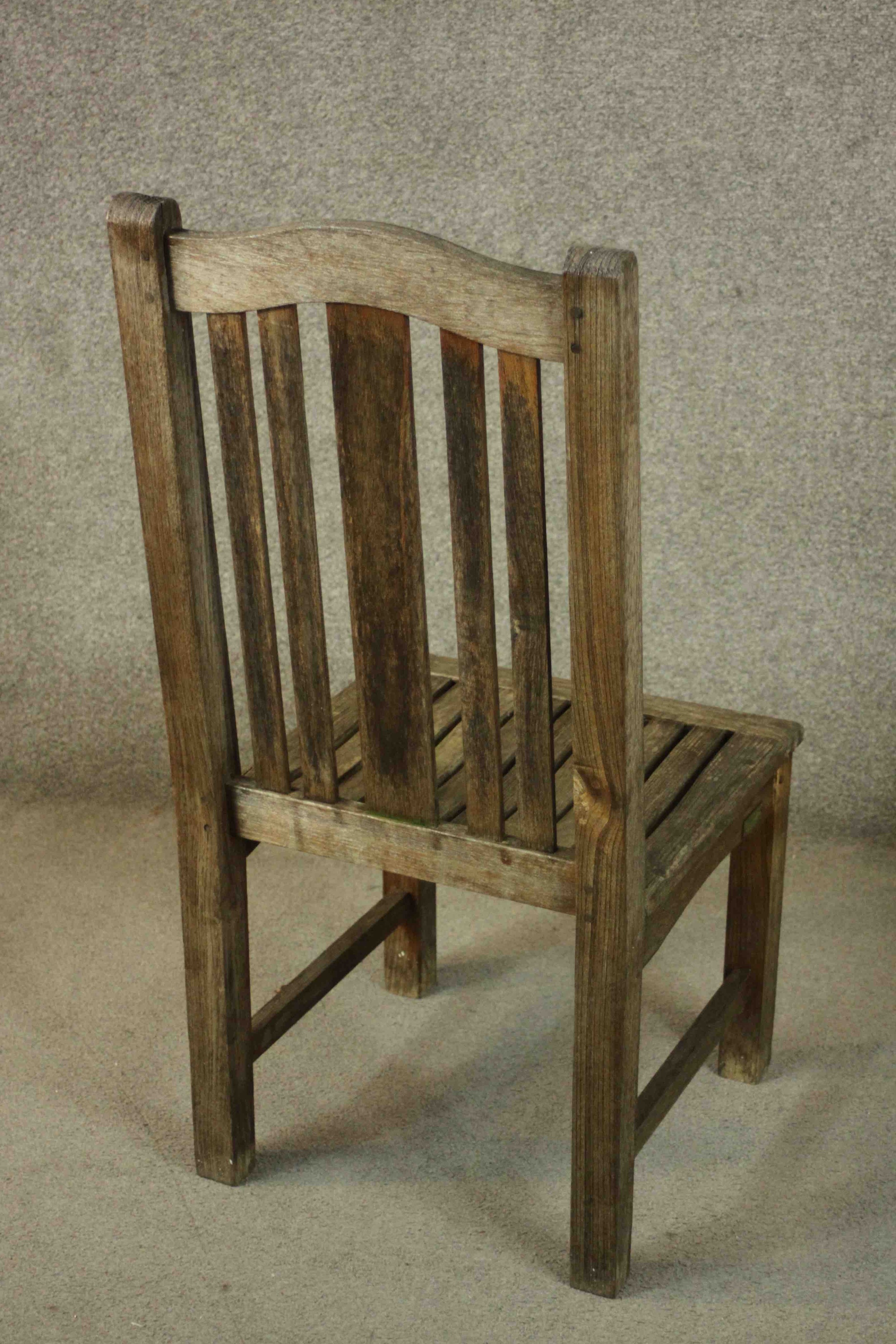A set of four contemporary Barlow and Tyrie oak garden dining chairs, with slatted seats. - Image 7 of 9