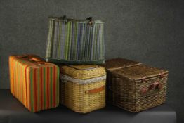 A collection of three woven baskets and a suitcase. H.25 W.53 D.36cm. (largest)