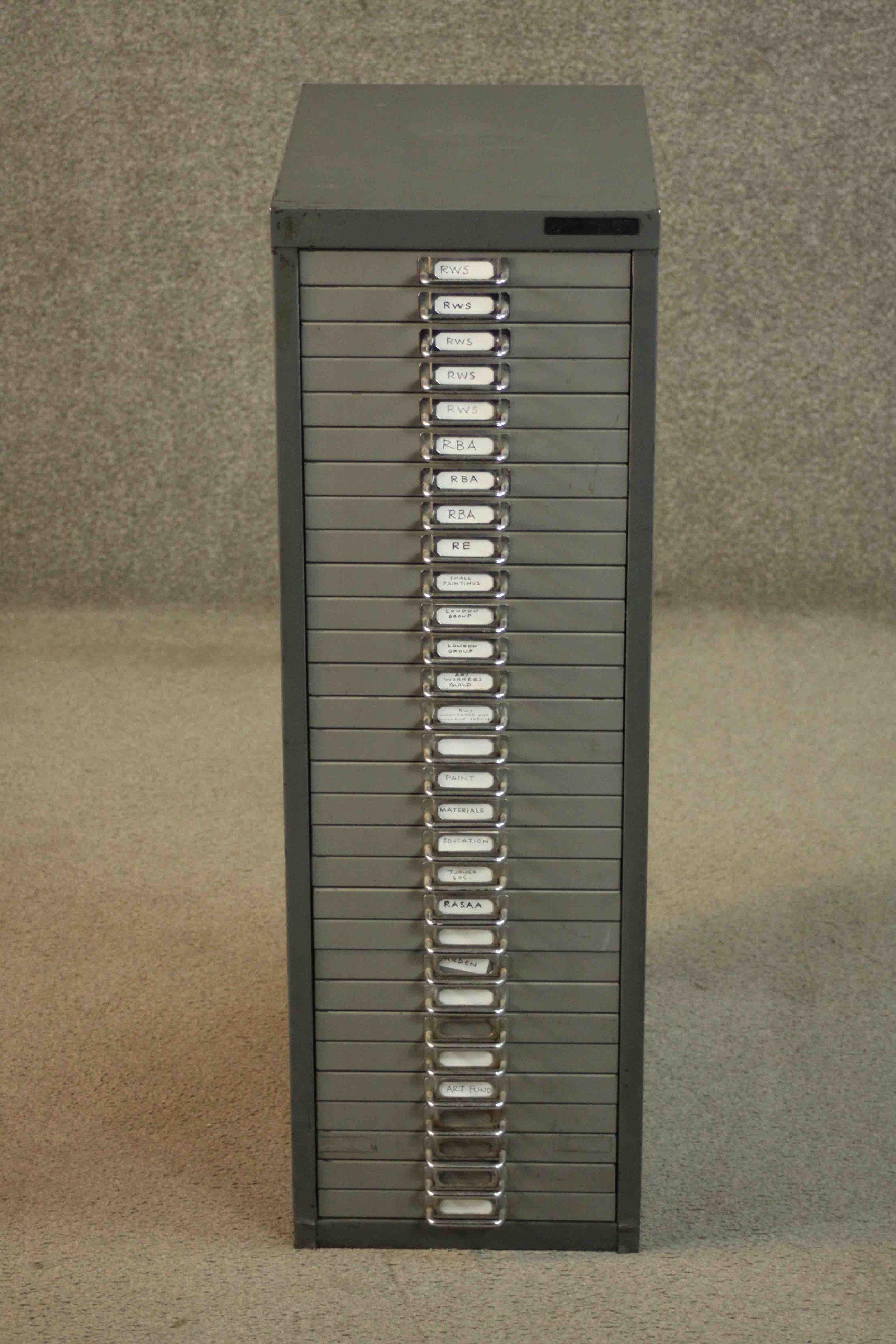 A mid to late 20th century painted steel filing cabinet, in two shades of grey with thirty