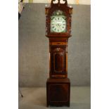 A George III Sheraton style flame mahogany and satinwood inalaid longcase clock, the hood with a