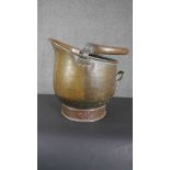 A Victorian planished copper coal bucket with a swing handle. H.37 D.37cm.