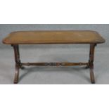 A Bevan Funnell Ltd 'Reprodux' mahogany coffee table, with a tooled leather top on lyre end supports
