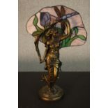 A Tiffany style table lamp, in the form of a maiden, with a stained glass shade to the rear