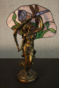 A Tiffany style table lamp, in the form of a maiden, with a stained glass shade to the rear