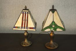 Two reproduction Tiffany style table lamps, with stained glass shades, on similar bases to each