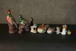 A collection of eight hand painted porcelain and ceramic birds, including a Chinese style gilded