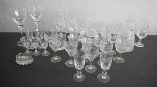 A collection of drinking glasses, including a set of five hand cut crystal tumblers, two wine