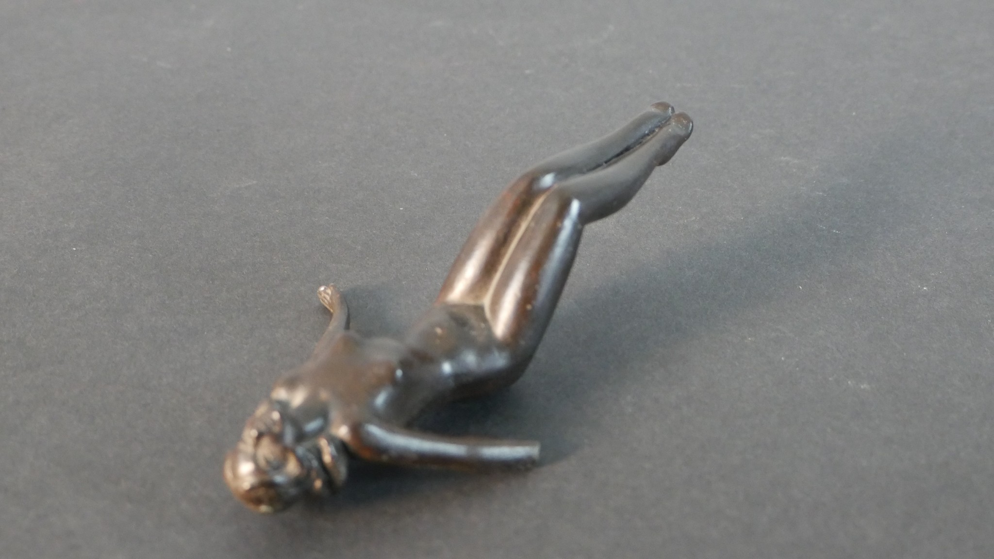 A bronze figure of a man smoking a pipe along with a spelter figure of a female swimmer (arm broken) - Image 7 of 8