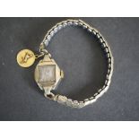 A ladies vintage cocktail watch with 18 carat yellow gold zodiac charm. Stamped 750.