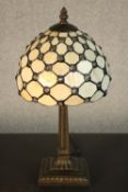 A reproduction Tiffany style table lamp, with a dome shaped stained glass shade on a columnar