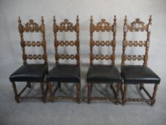 A set of four Spanish walnut ladder back dining chairs, the back carved with C scrolls over a