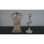 An Art Deco chrome candlestick in the form of a nude dancer along with an Art Nouveau style pewter
