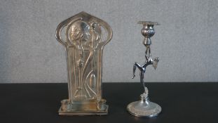 An Art Deco chrome candlestick in the form of a nude dancer along with an Art Nouveau style pewter