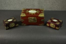 A group of three similar Chinese jewellery boxes, the lid of each set with a carved oval jade or