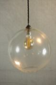 A contemporary spherical transparent glass pendant lamp. Dia.23cm