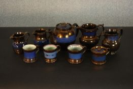 A collection of 19th century copper lustre items, comprising a teapot, jugs, cups, and a preserve