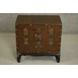 A small Chinese or Korean elm chest on stand, with brass mounts, fitted with two doors. H.40 W.56