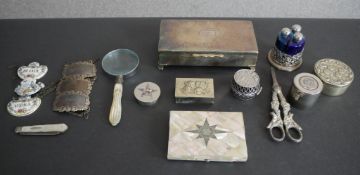 A collection of silver plated items, including a cigarette box, mother of pearl and white metal card