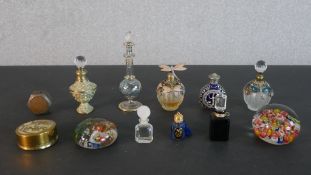 A collection of embellished scent bottles, paperweights and a penny cigarette lighter. H.13cm (