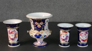 Three 19th century hand painted porcelain vases with floral design panels, royal blue ground and