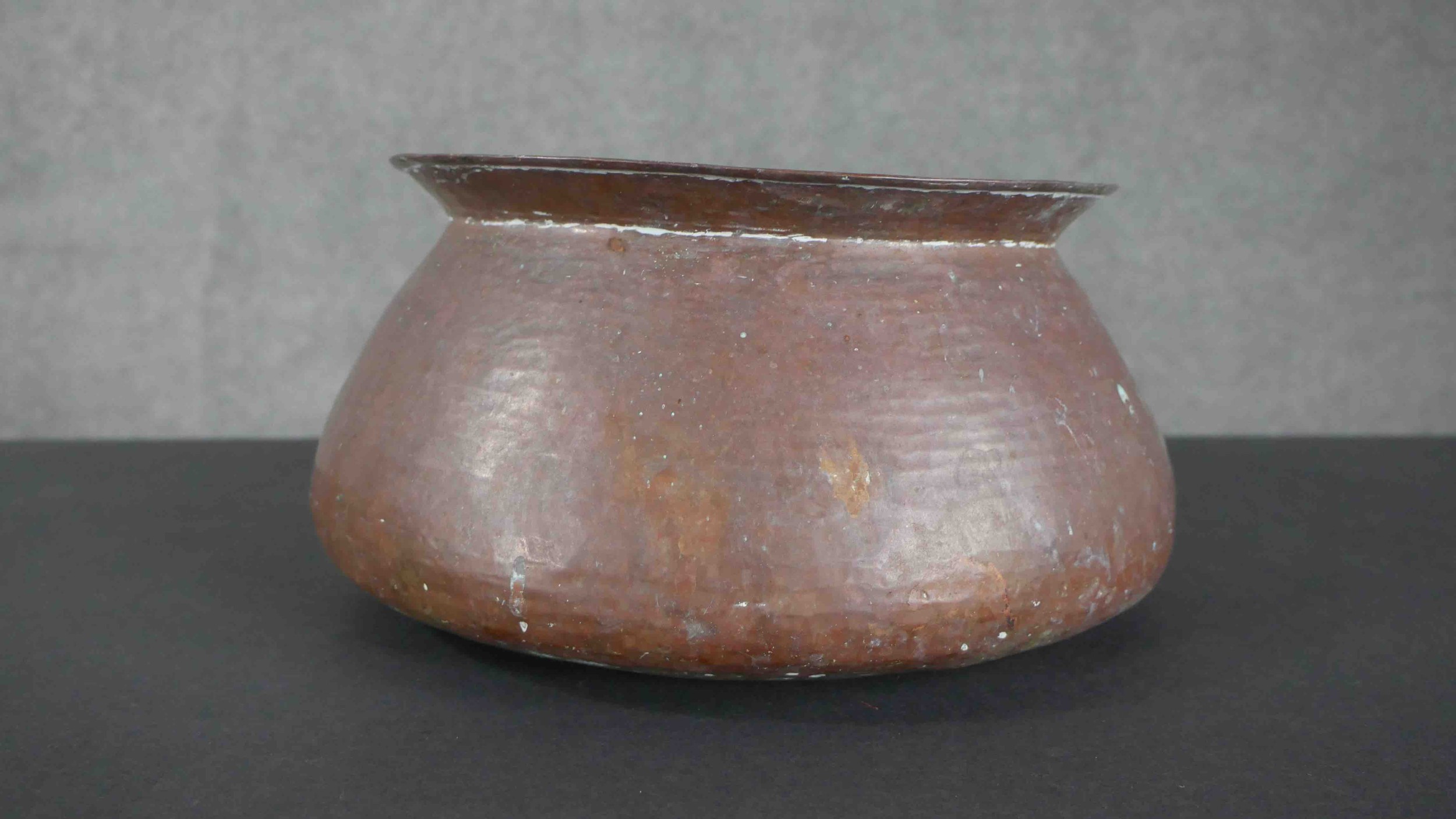 Two early 20th century Indian hammered copper lipped water bowls along with two swing handled - Image 3 of 4