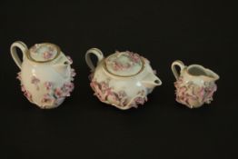 Three pieces of 19th century Meissen pink floral encrusted porcelain, miniature coffee pot, tea