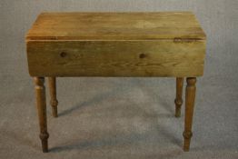 A Victorian pine Pembroke table, with two drop leaves, missing a drawer, on turned legs. H.75 W.98