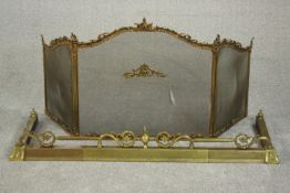 A Victorian Rococo Revival brass fireguard, the serpentine top cast with scrolling rocaille