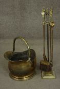 A Victorian brass coal bucket with a swing handle, together with a brass fireside companion set