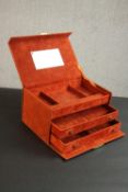 A burnt orange suede effect travelling jewellery case, with two sliding drawers and a sectioned