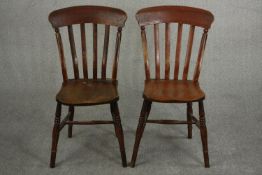 Two late 19th century bar back kitchen chairs, with elm seats on turned legs joined by H stretchers.