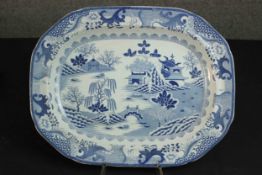 A 19th century blue and white transfer design ceramic Chinese willow pattern meat plate. Maker's