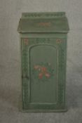 A Victorian bedside cabinet, later painted and distressed, with a gallery back over a single door,