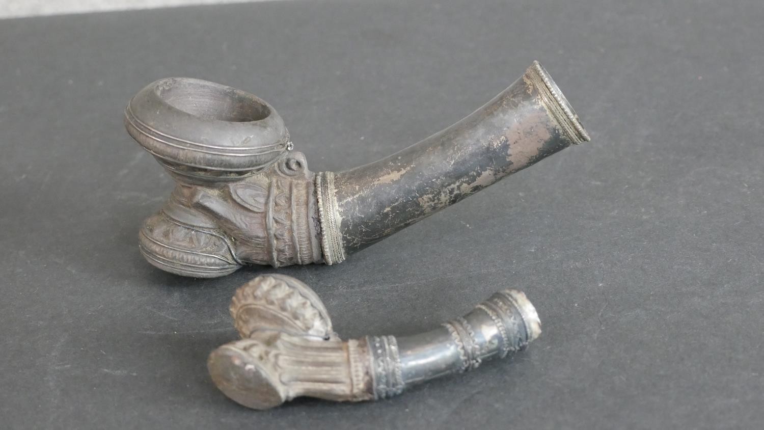 Two 19th century Burmese white metal (tests as silver) smoking pipe bowls. H.9 W.16 D.5cm (largest)
