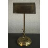 An Edwardian brass banker's desk lamp, with an adjustable shade and a circular step down base. H.