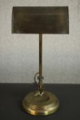 An Edwardian brass banker's desk lamp, with an adjustable shade and a circular step down base. H.