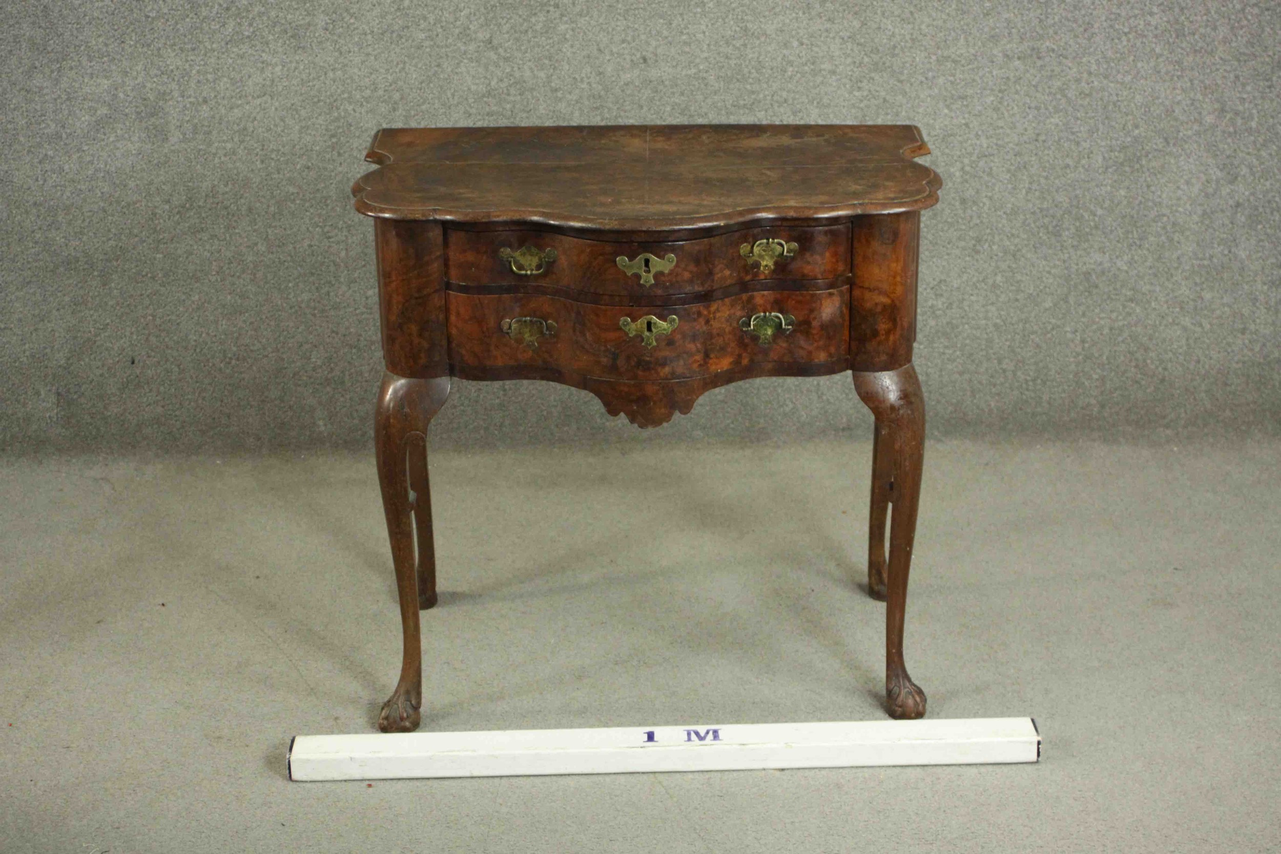 An early 18th century figured walnut lowboy of serpentine form, the top with a moulded edge over two - Image 2 of 8