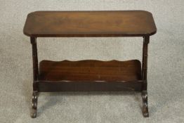 A Georgian style flame mahogany coffee table with magazine rack undertier. H.47 W.67 D.33cm.