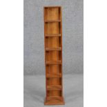 A contemporary cherry wood CD rack, seven tiers high. H.107 W.23 D.20cm.