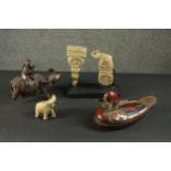 A collection of carved items, including a Chinese water buffalo with man on his back, a painted duck