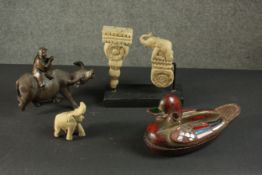 A collection of carved items, including a Chinese water buffalo with man on his back, a painted duck