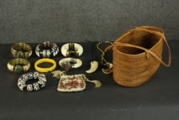 A collection of tribal jewellery including three bone and agate bangles, a carved bakelite rose