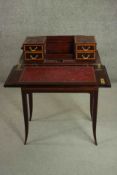 A circa 1900 mahogany and satinwood inlaid writing table, of rectangular form, the top opening to