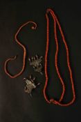 A collection of early 20th century Oriental red coral jewellery. A three strand Chinese coral