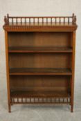 A Victorian walnut dwarf open bookcase with galleried spindle back above three shelves on turned